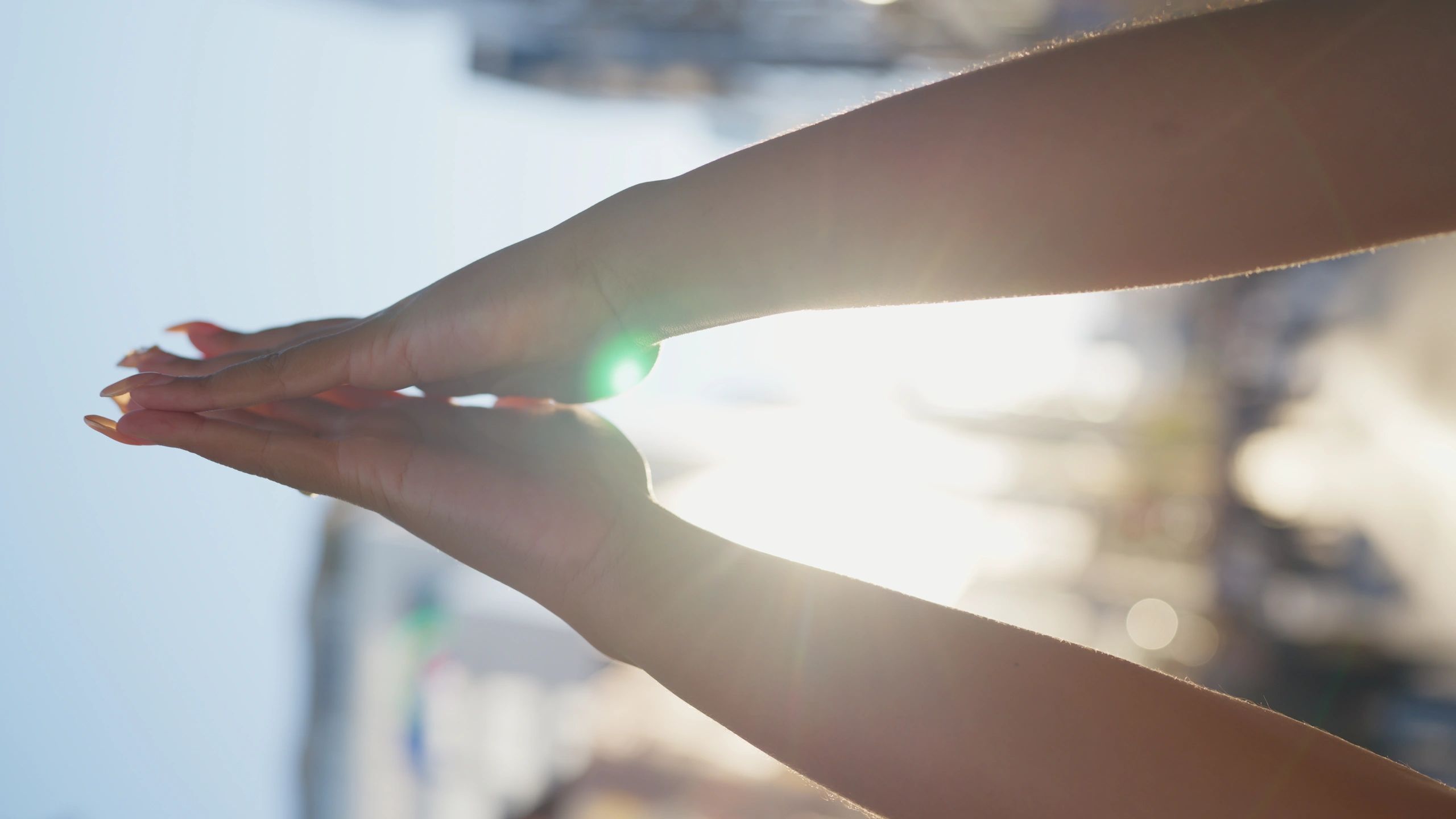 Hands in a calm prayer pose amid a busy city background