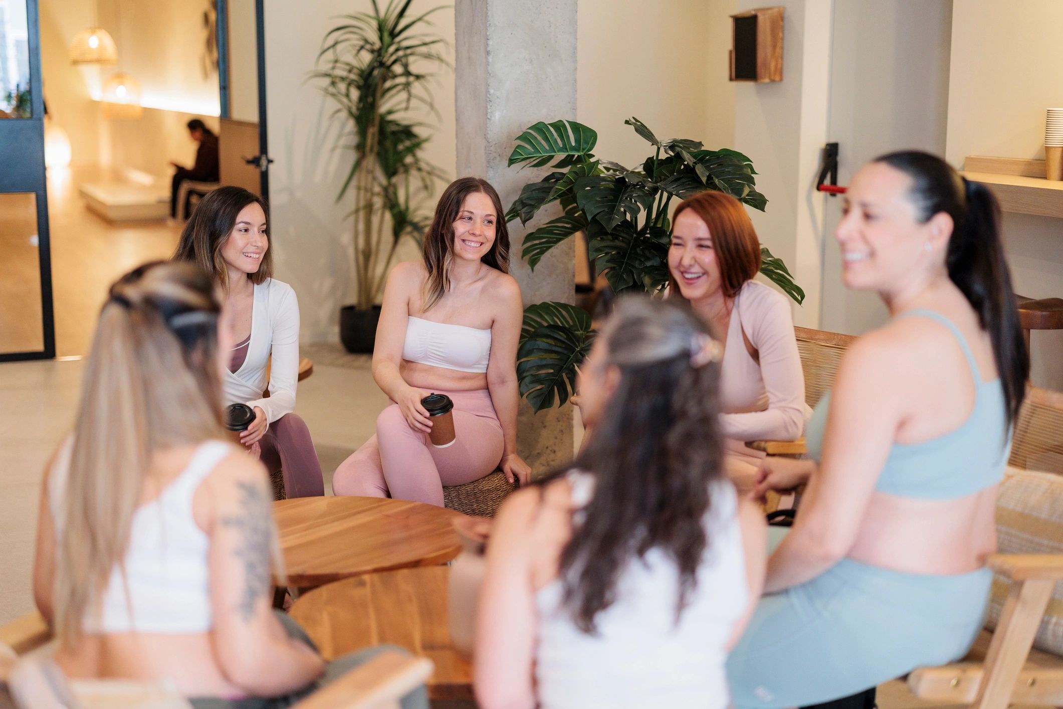 Women friends enjoying coffee and conversation in wellness space
